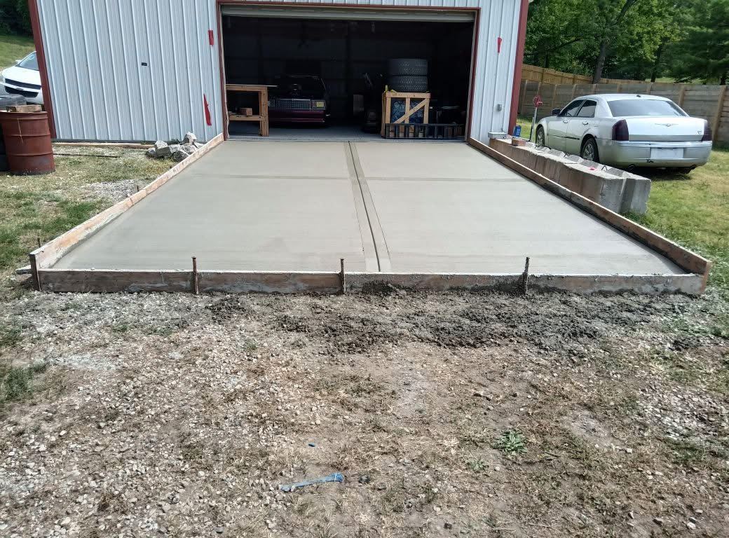 Completed concrete slab and approach pad at a garage